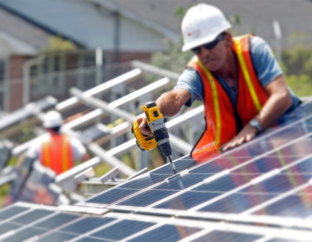 Evolve Solar installer securing a panel on a roof
